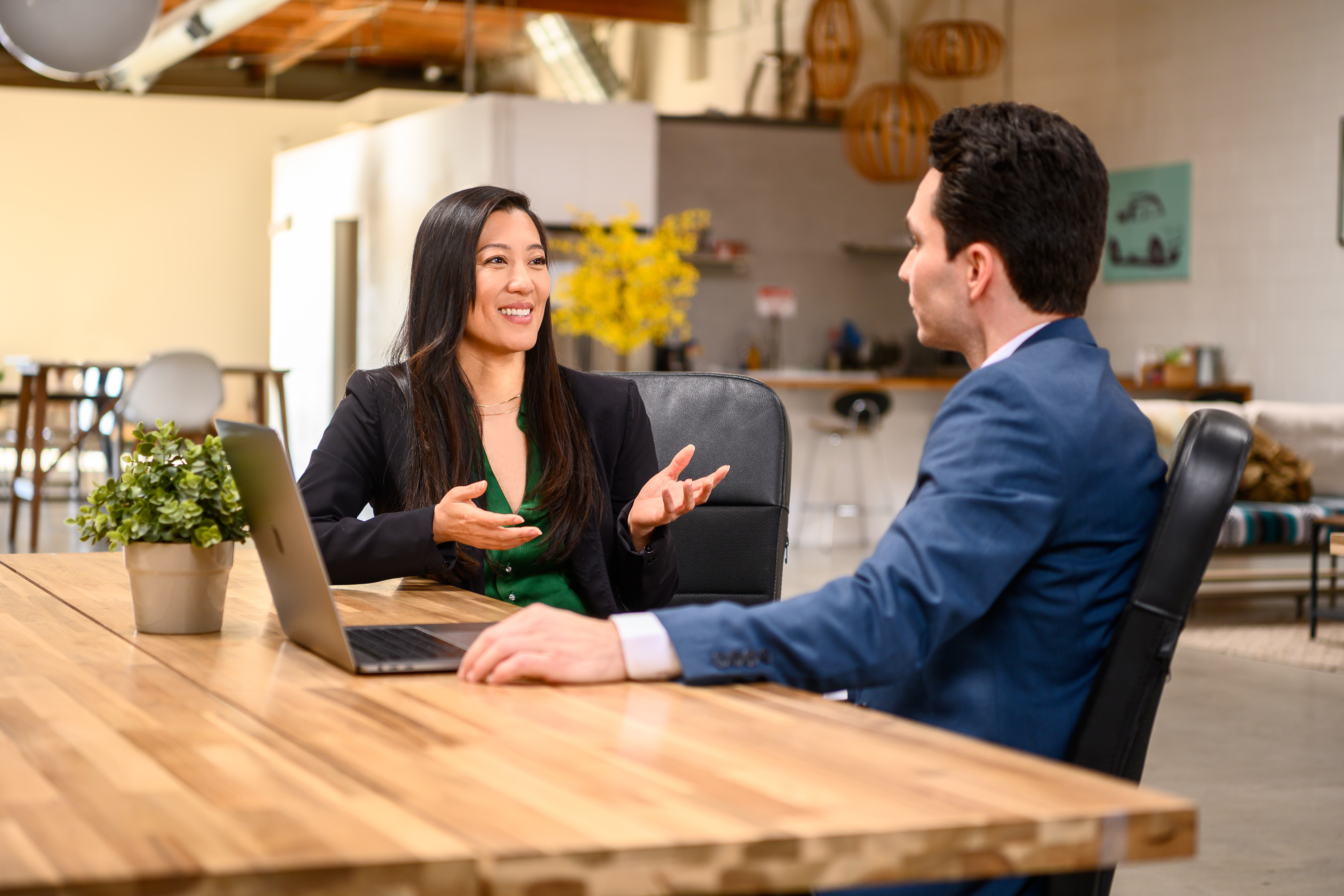 Two regional leaders in conversation over a laptop